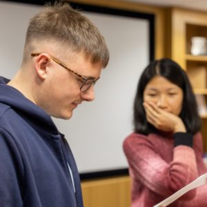 2 graduate staff trying to solve a problem in a training session