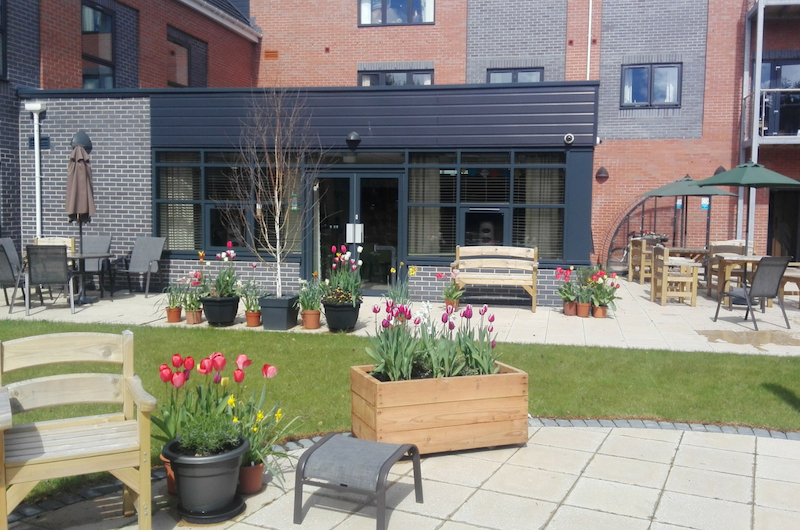 Exterior courtyard view of WWH extra care building Llys Glan yr Afon