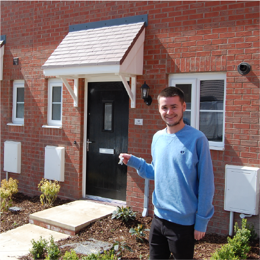 Happy WWH Resident holding keys outside new home