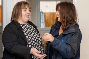 Housing Officer handing over keys to new resident