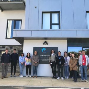 Multiple WWH staff members posing outside Plas yr Ywen extra care scheme
