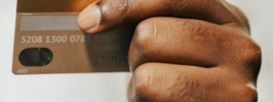 Person holding bank card and mobile phone