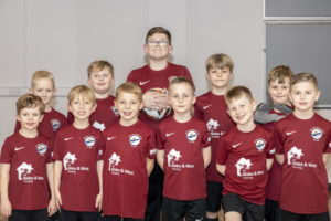 Shotton Town United football team wearing kit sponsored with WWH logo on front