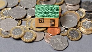 House model with coins. Home finance concept
