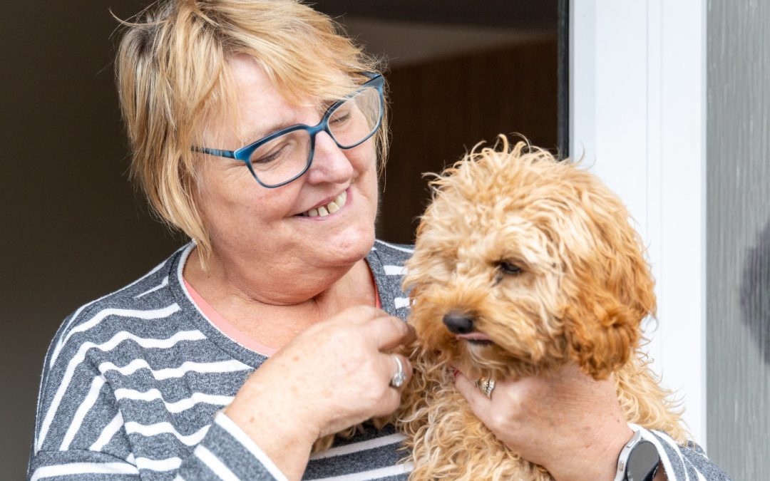 WWH resident cuddling her dog