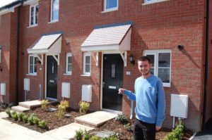 WWH resident hold house keys stood outside their new property