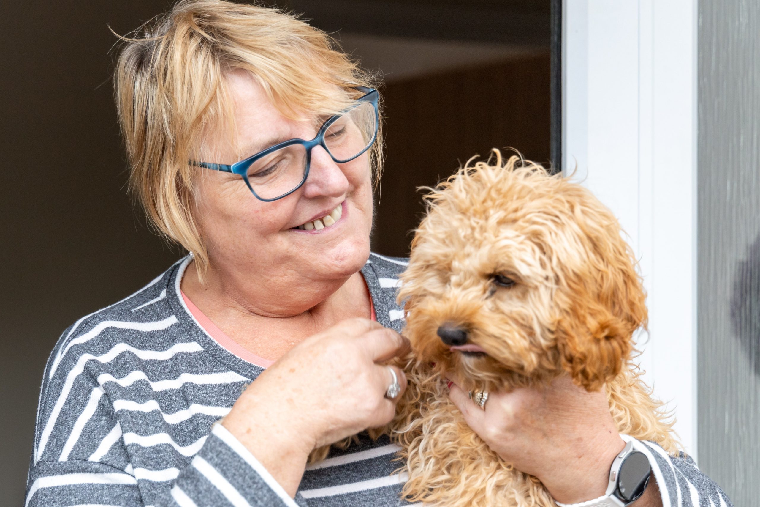 WWH resident smiling holding pet dog