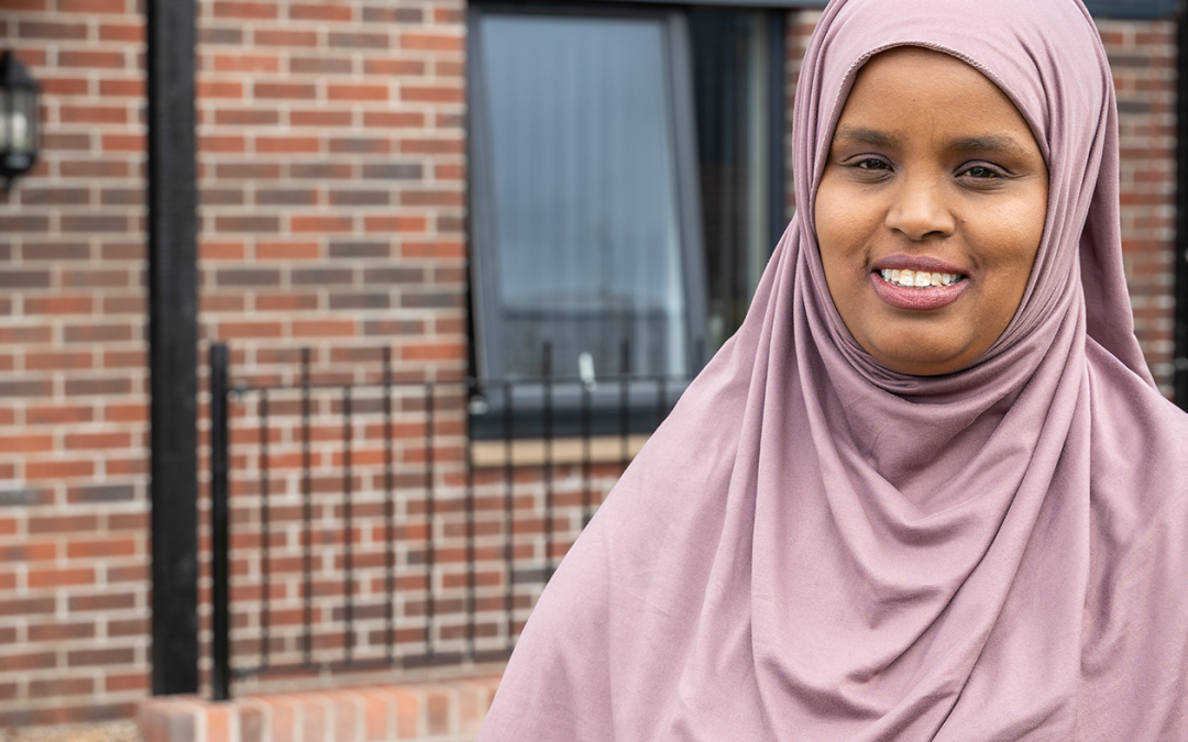 WWH resident wearing head scarf smiling outside front of property (1)