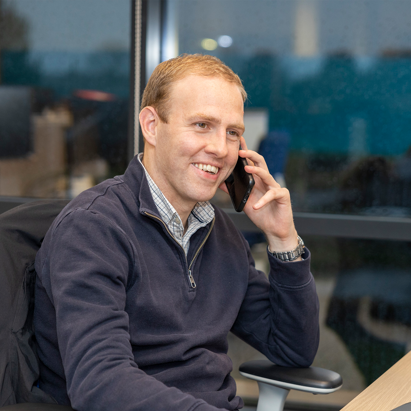 WWH staff member smiling whilst talking on a headset