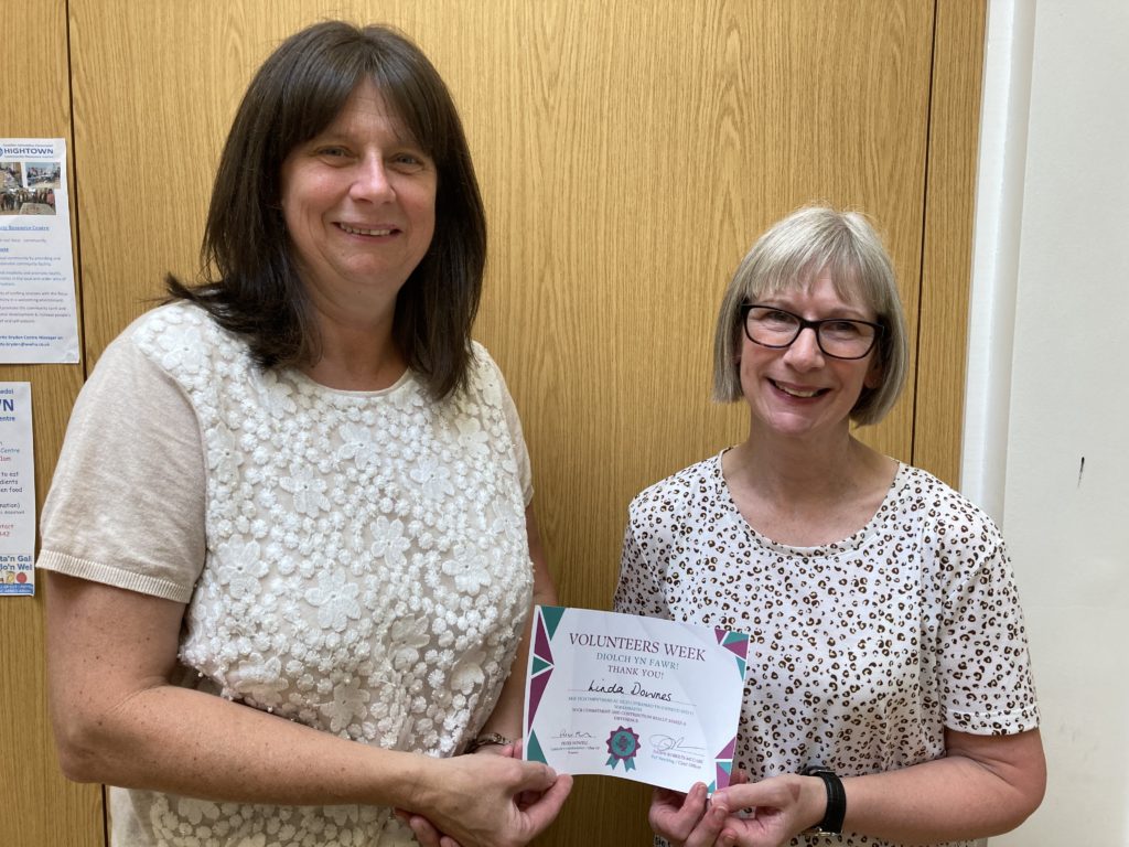 Annette Bryden (left) presents Linda Downes with volunteering award