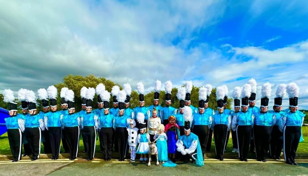 members of Southern XL marching jazz band lined up in their blue and black uniforms