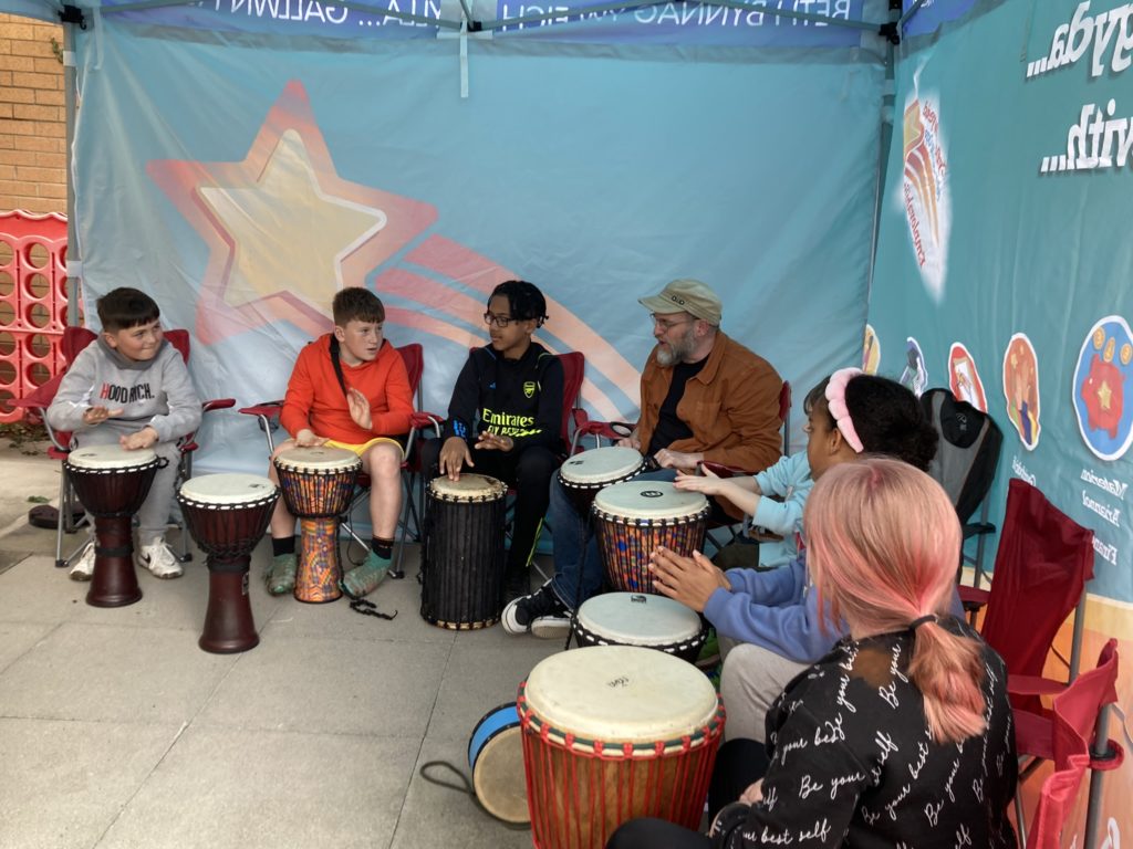 Children and instructor playing drums