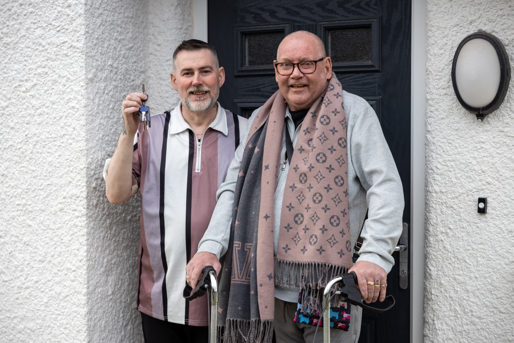 Andrew and Steven Benton outside new home