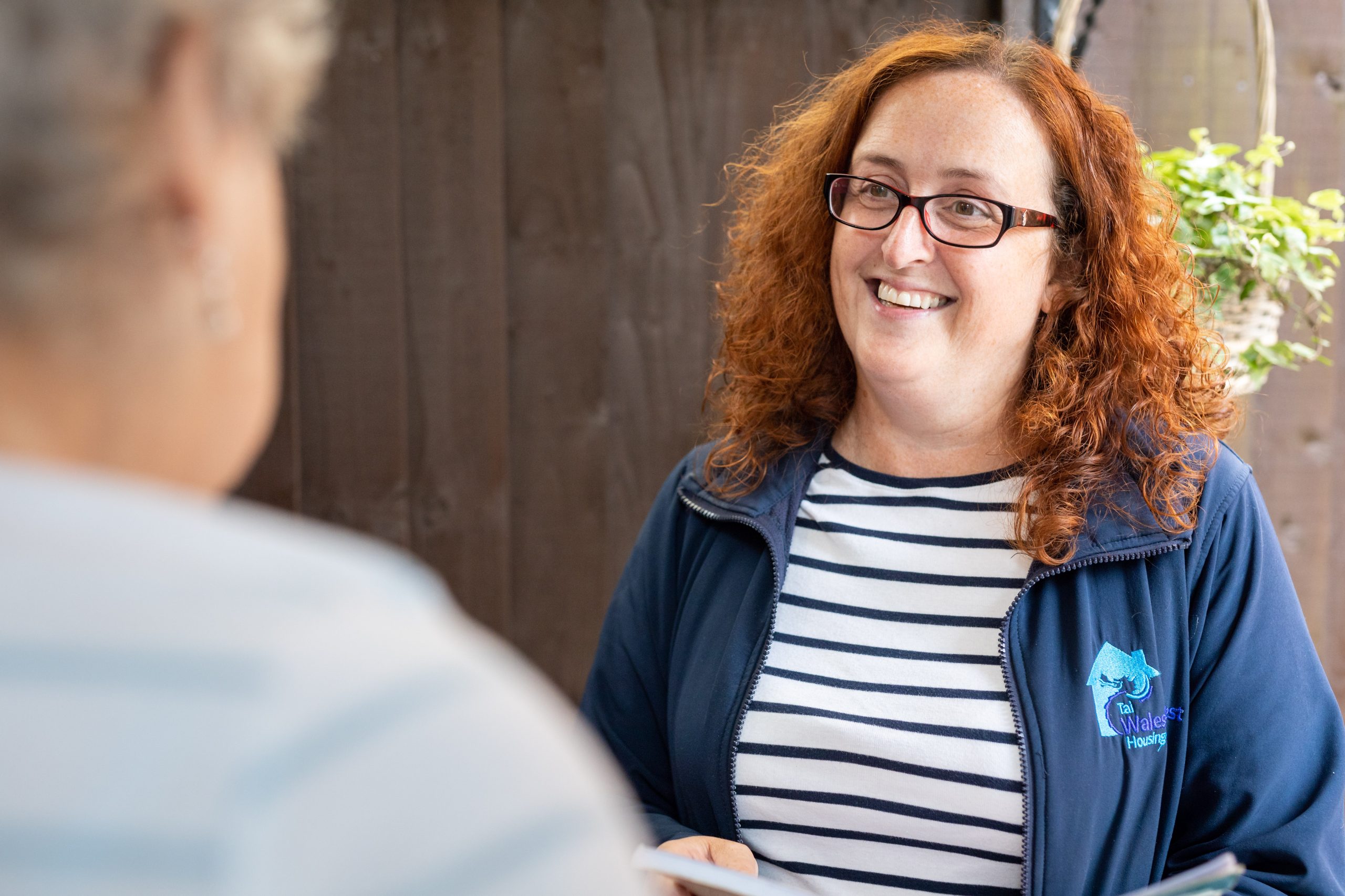 WWH resident talking with Housing Officer smiling at the front door