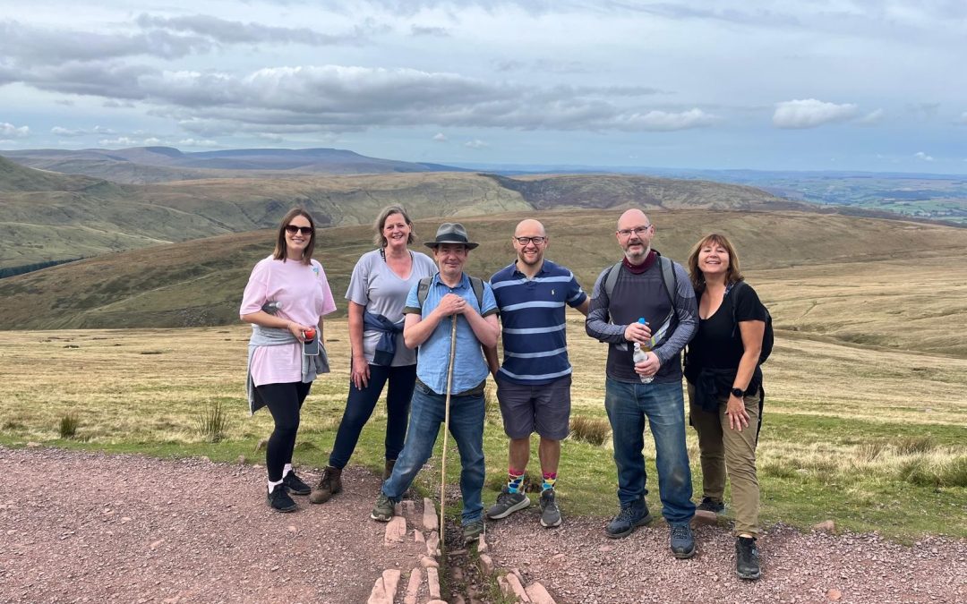 Staff Cyllid yn codi punnoedd i elusen drwy her Pen y Fan