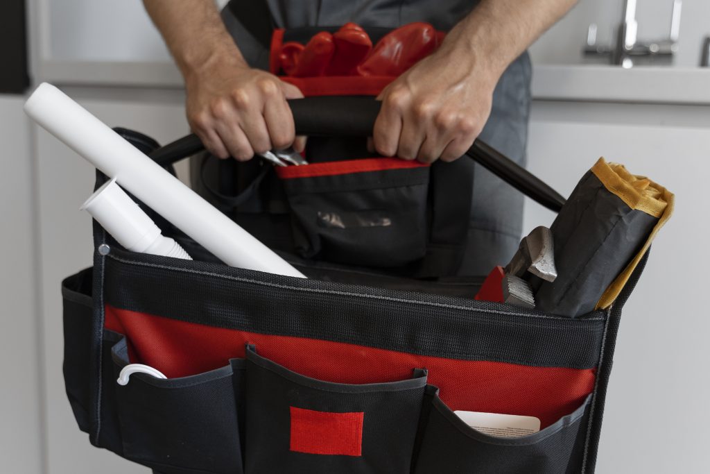 front-view-man-working-as-plumber image of a tool box